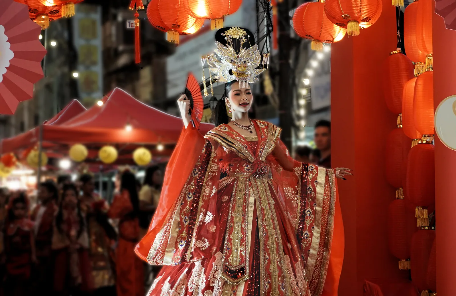 Il Capodanno cinese tra lanterne e costumi tradizionali Donna in costume tradizionale rosso tra lanterne cinesi durante le celebrazioni del Capodanno cinese in Thailandia